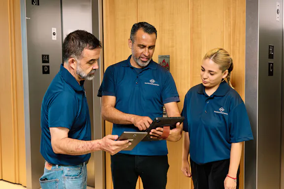 Employees review a tablet
