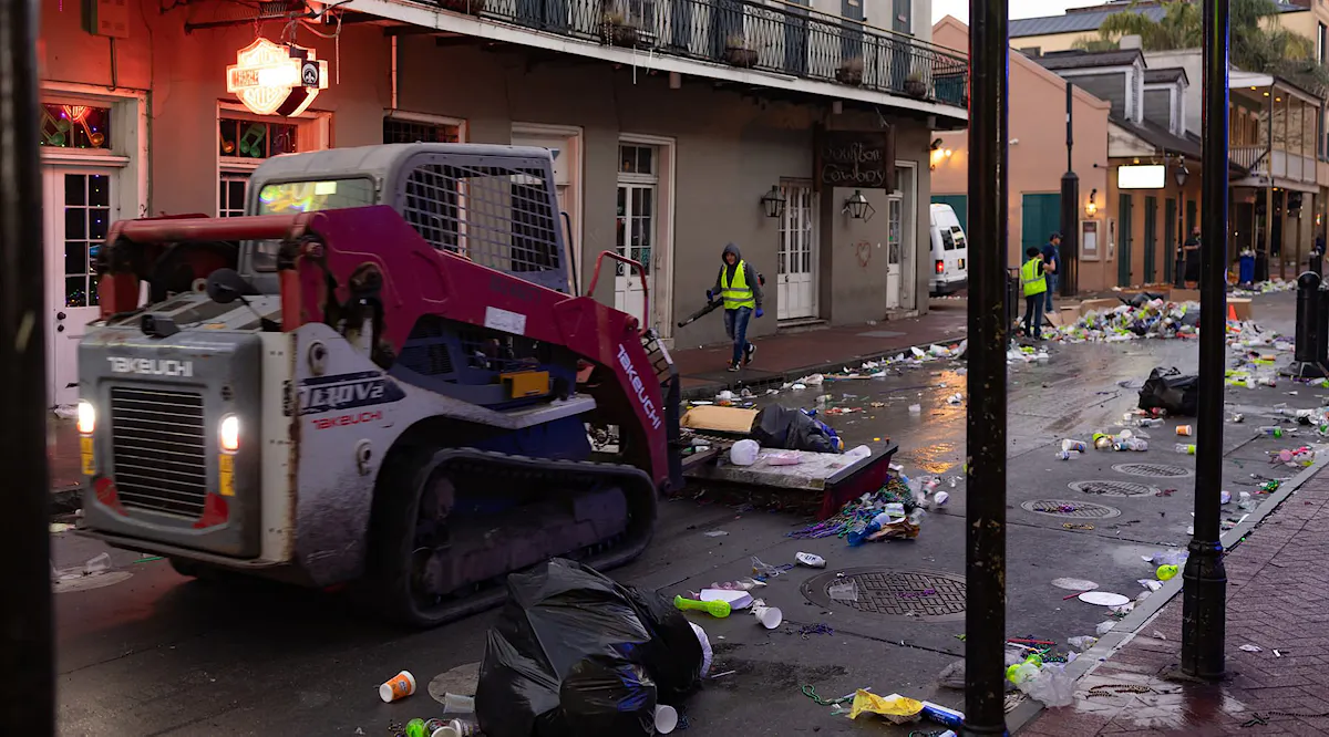 KBNS crew members clean the streets after Mardi Gras