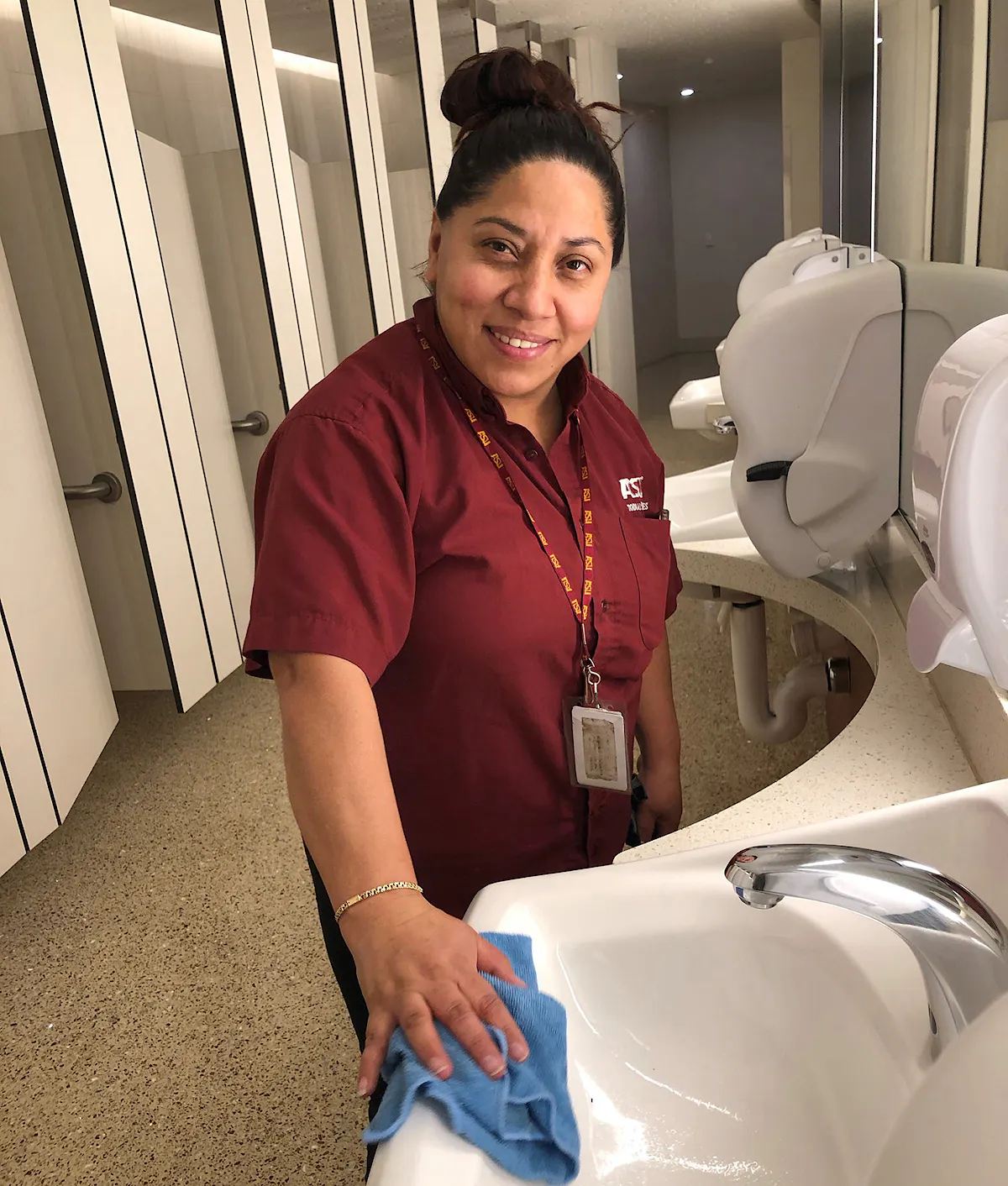 KBS crew member cleans in a facility restroom